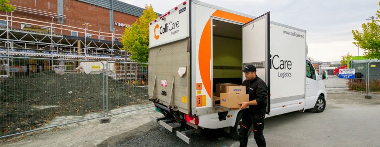 A ColliCare driver taking parcels for express delivery out of his van.