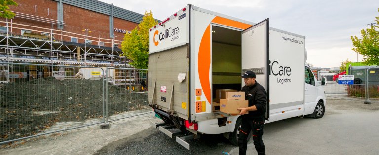 A ColliCare driver taking parcels for express delivery out of his van.