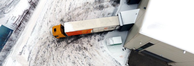 Looking over a branded ColliCare trailer from above parked to the storage, loading and unloading goods 