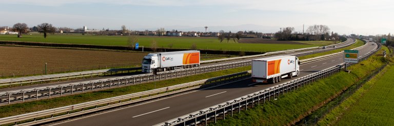 Two ColliCare trucks with trailers driving on a highway