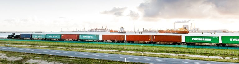 A cargo train passing by the harbour of Rotterdam.